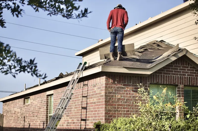 Professional roofer working on a residential roof in Cicero